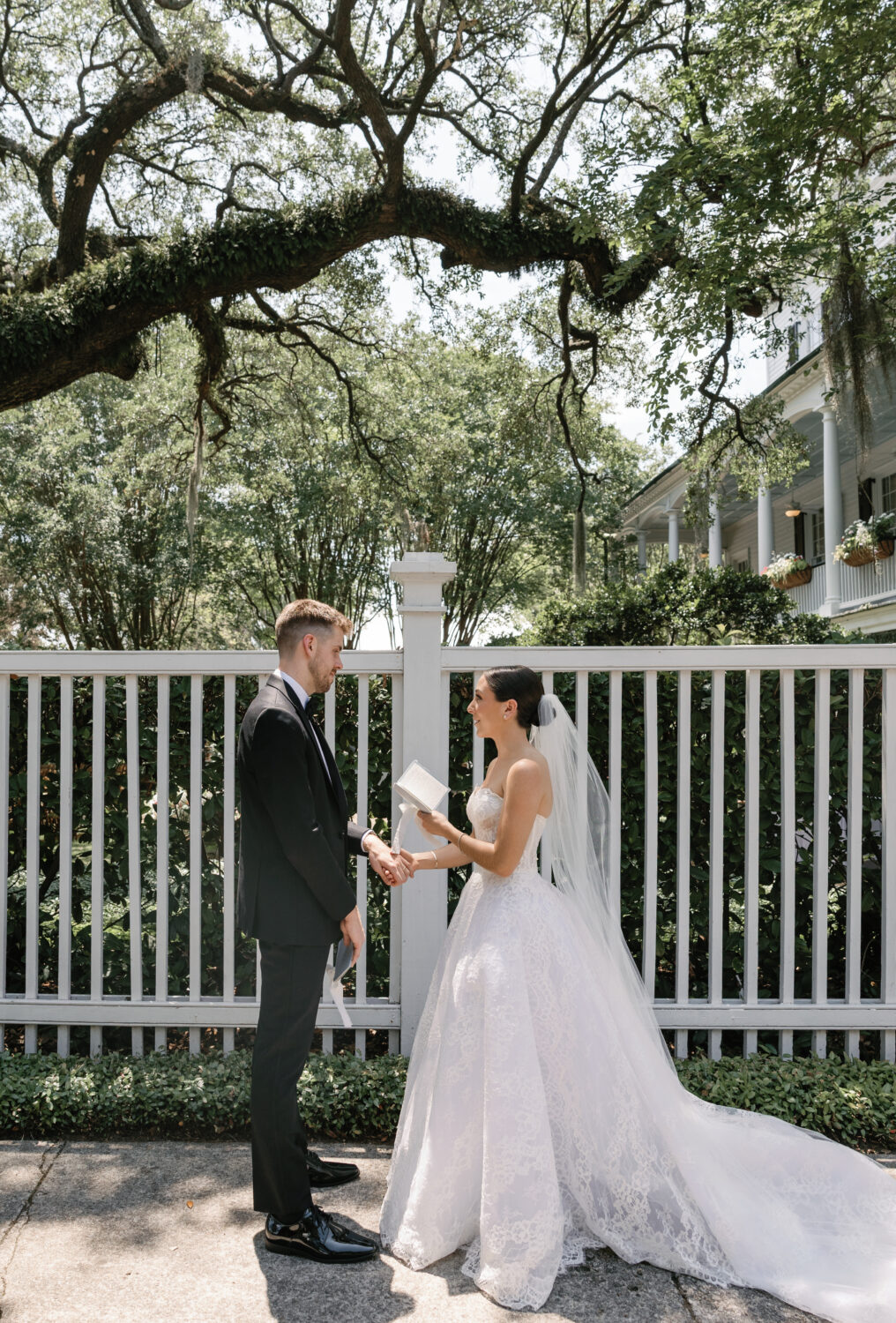 Bride and groom share vows outside under a tree